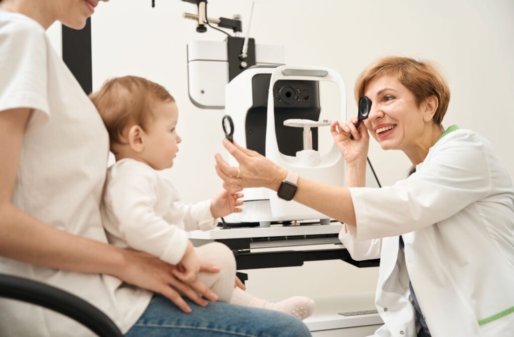 An eye doctor assessing an infant's visual development during their routine eye exam.