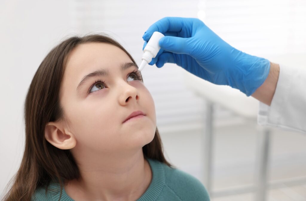 A child receiving eye drops for myopia management.