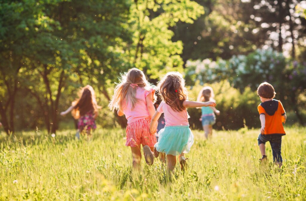 A group of kids running through tall grass