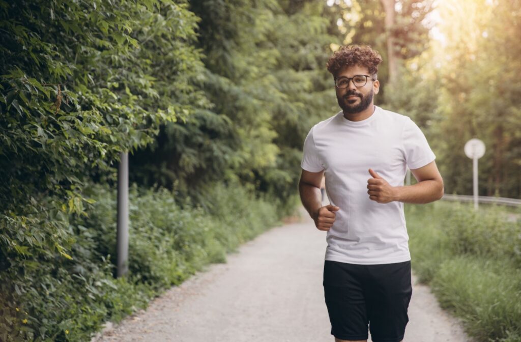 A person going for a run outside while wearing a pair of glasses