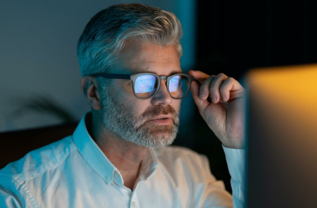 a person looking at a computer screen while wearing glasses